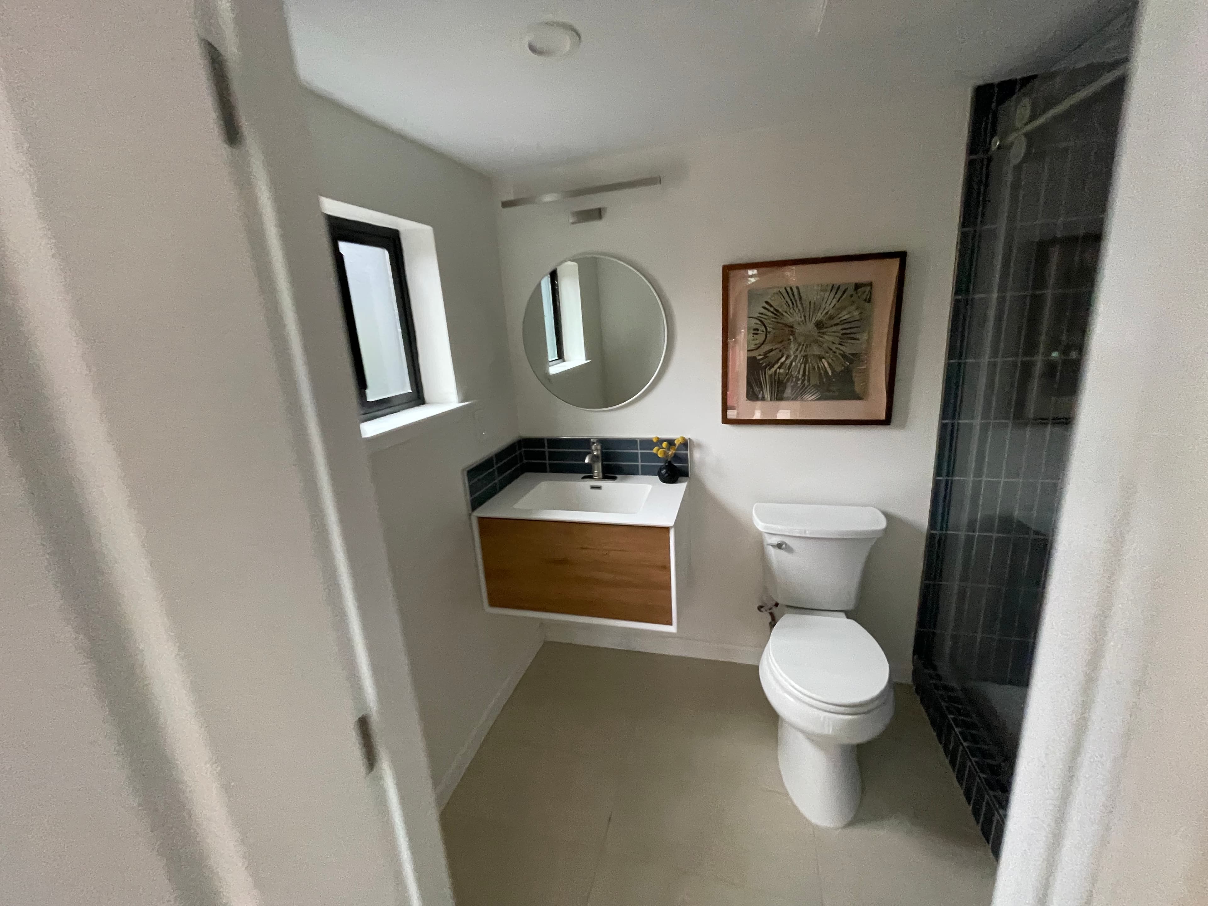 Contemporary bathroom with floating wood vanity