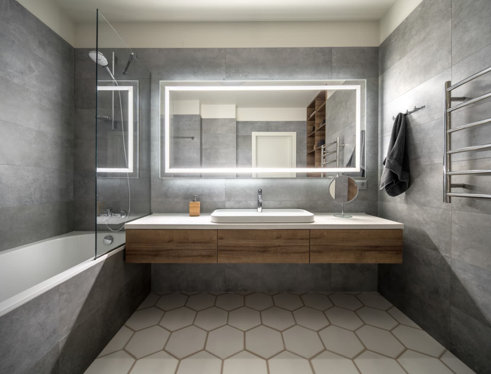 Modern bathroom remodel with large mirror and wooden vanity